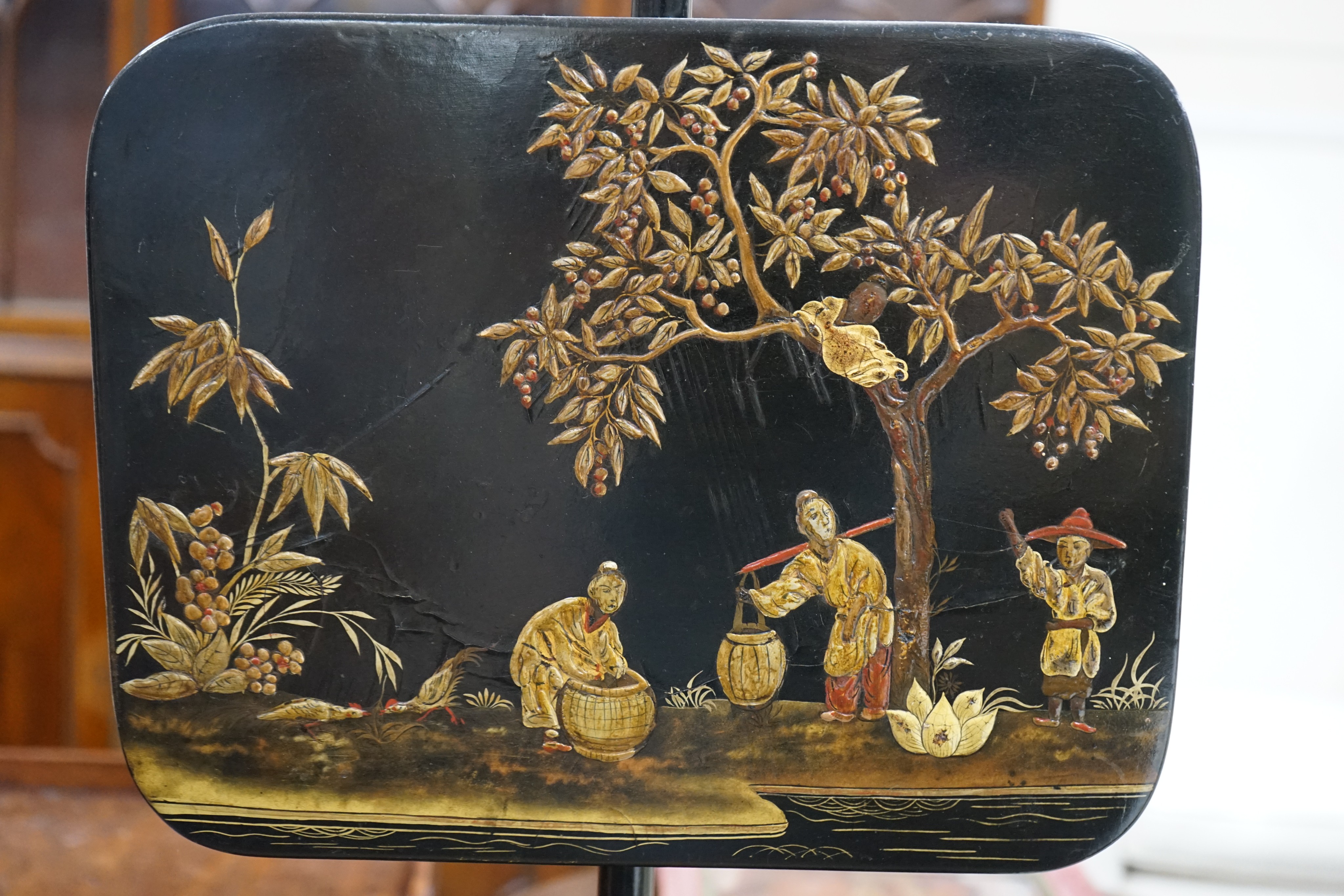 A pair of 19th century chinoiserie lacquer pole screens, height 152cm